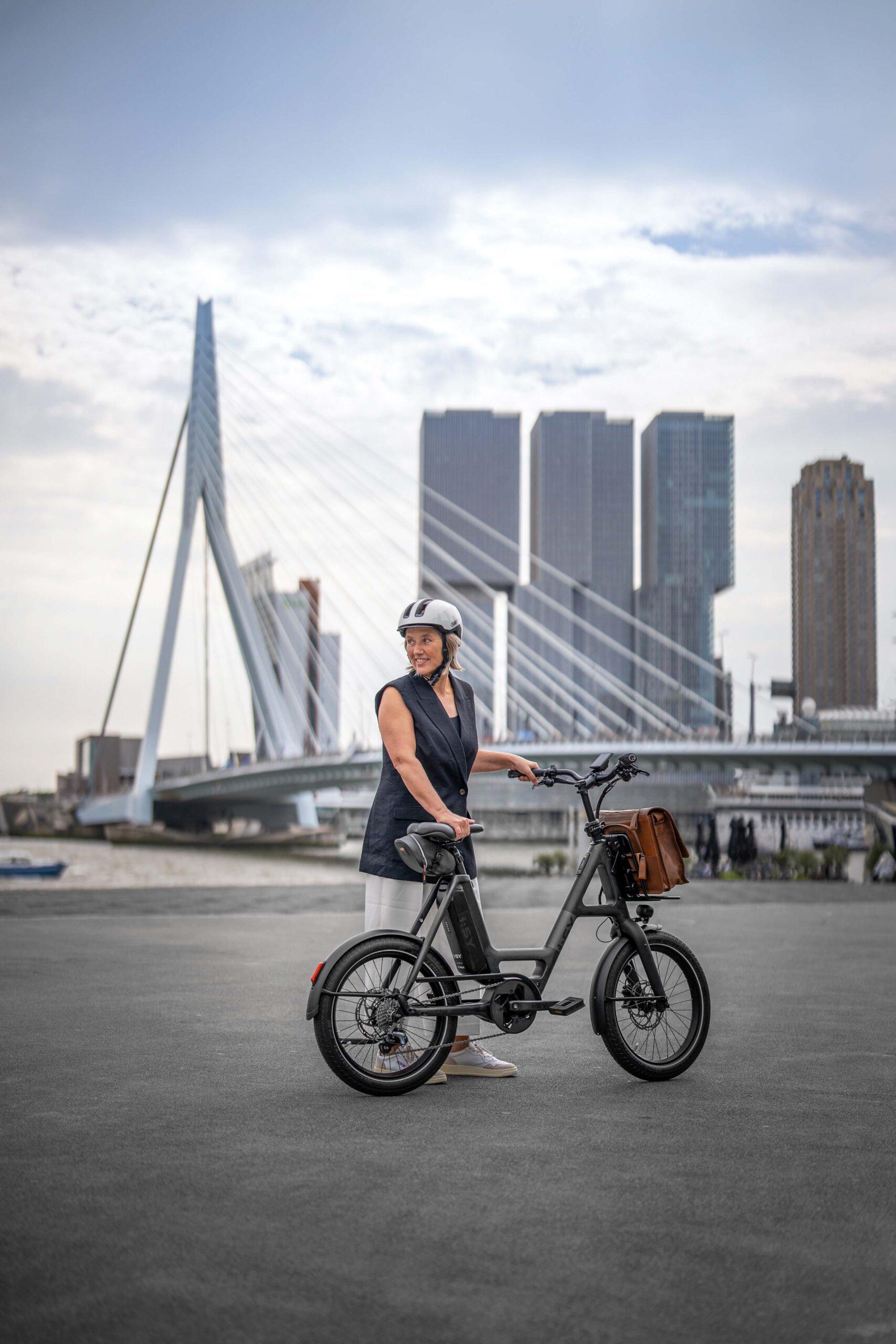 i:SY E-Bike mit Person vor Rotterdam Skyline – Szene aus einem Werbefilm für die Firma i:SY GmbH & Co. KG, produziert von Charlie Grashoff - The C/A Studio, Videoproduktion in Leipzig. Projekte deutschlandweit. Imagefilme, Corporate Videos, Brandfilme, Eventfilme, Industriefilme & mehr. Werbefilm Produktion. Fotografie Leipzig.